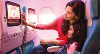 A mother browses through video games on her daughter’s SriLankan Airlines inflight entertainment system