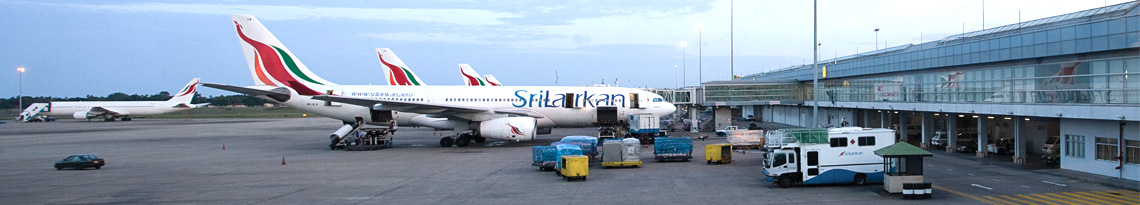 The apron of airport with a row of SriLankan aircraft and the hangar on the right